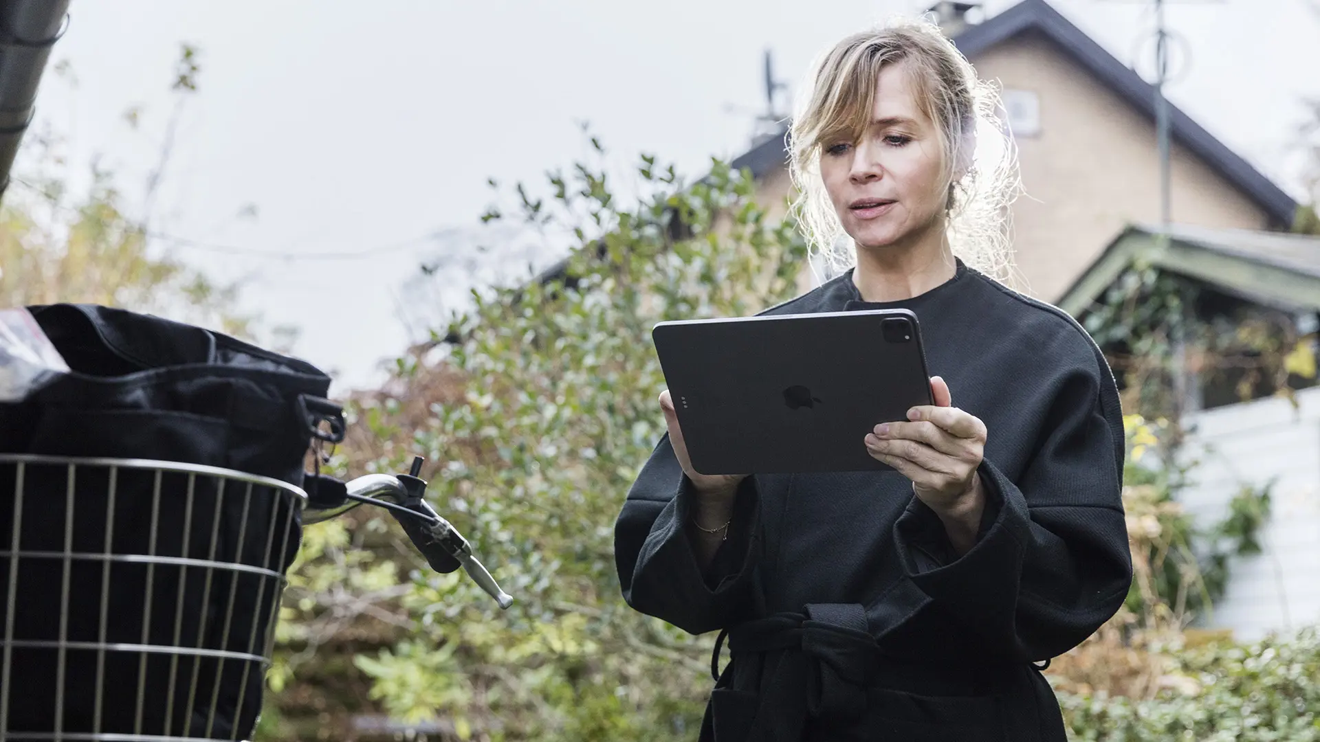 Social worker using tablet with bike