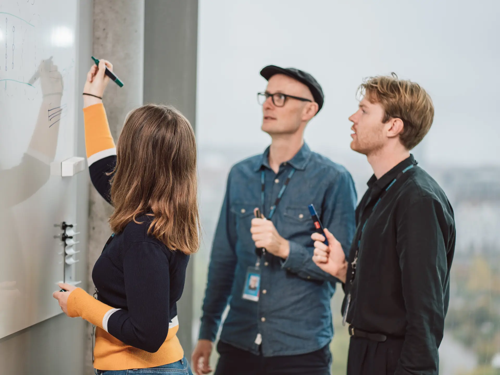 Employees working on a whiteboard
